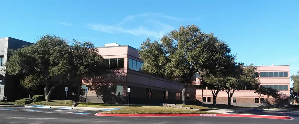 a high school surrounded by trees