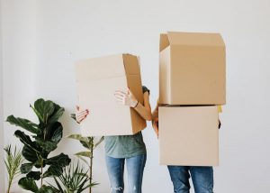 tenants holding boxes and moving out.