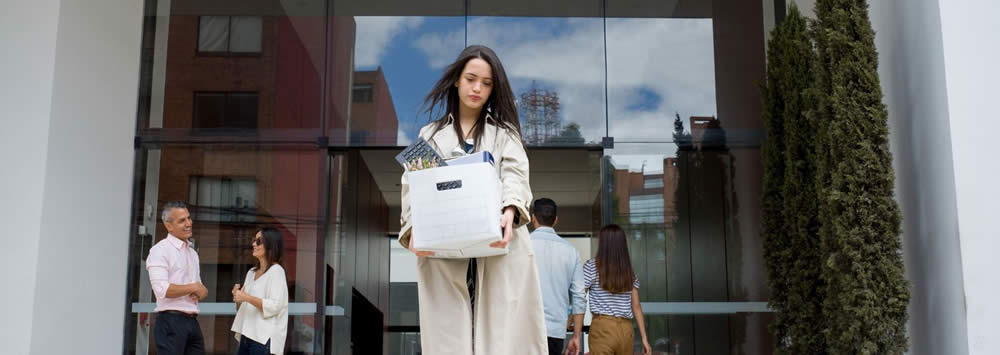 termination escort security dallas - woman walking out of a building with her office belongings