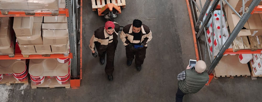 men walking through a warehouse