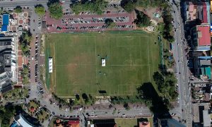 a soccer field from the air surrounded by cars